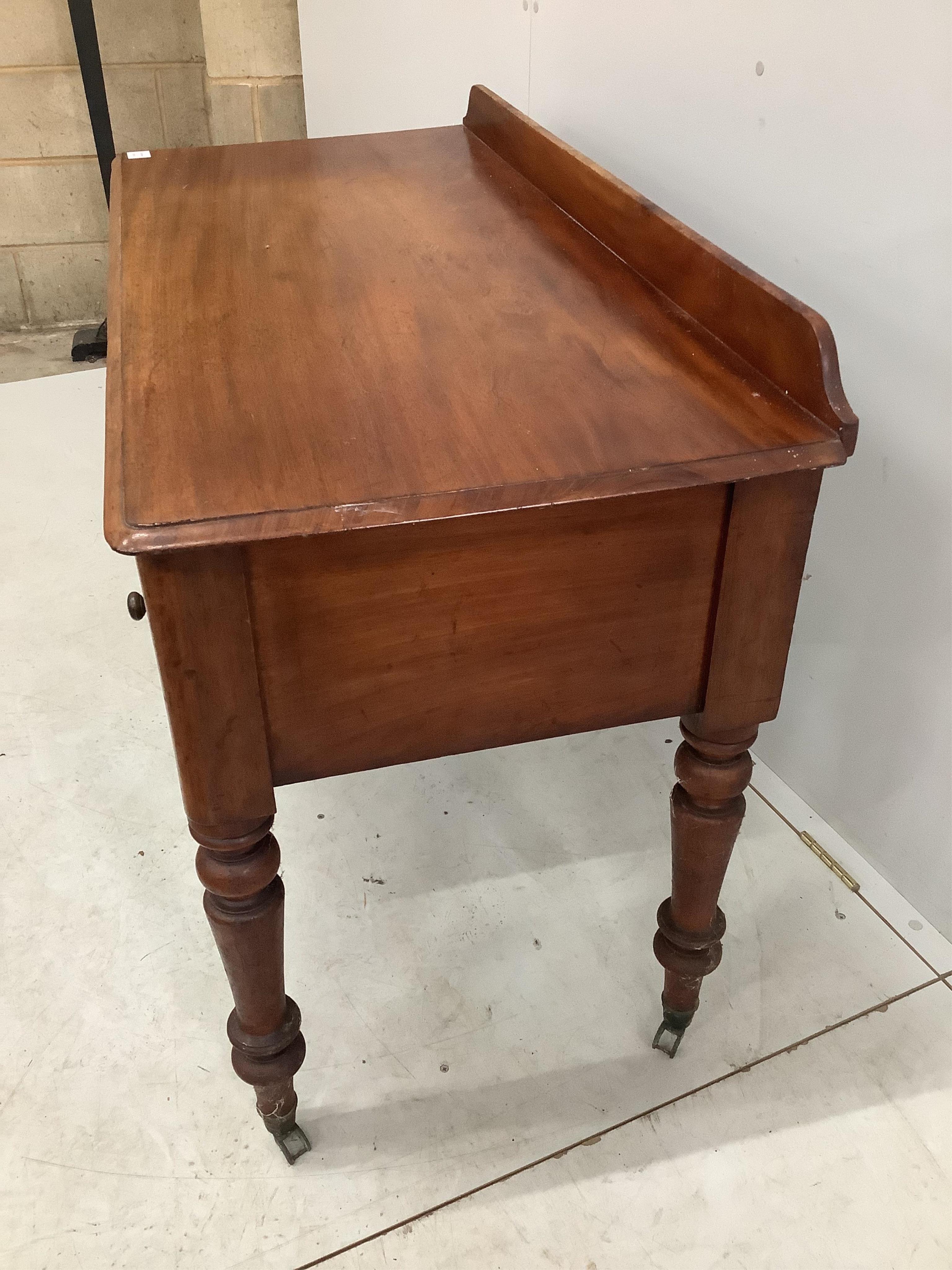 A Victorian mahogany four drawer side table, width 121cm, height 82cm. Condition - fair